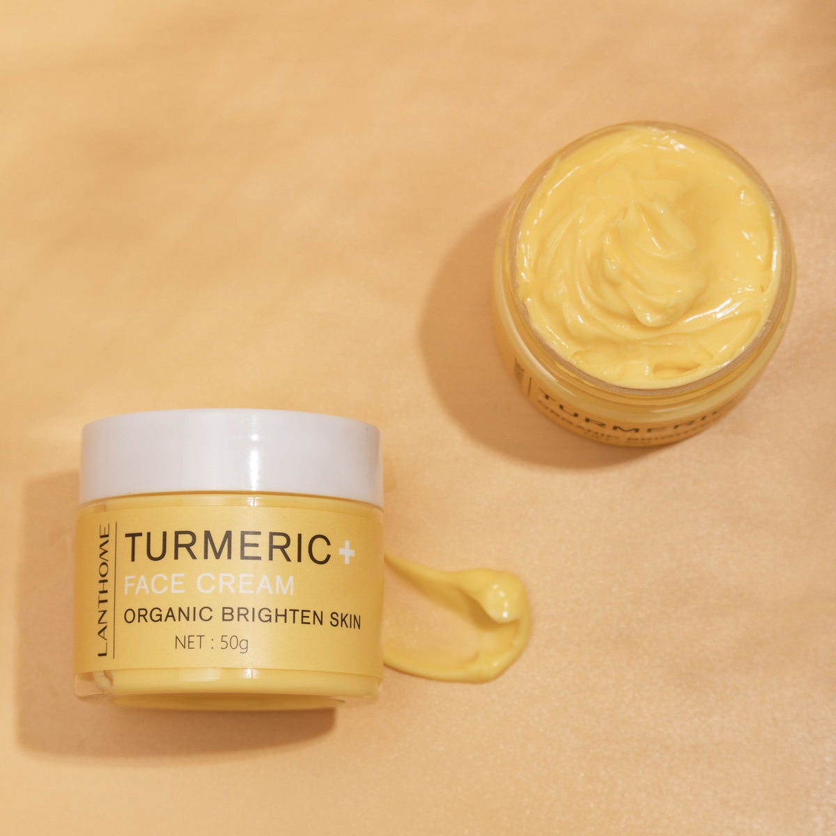 Travel-sized Milk Face Cream next to skincare tools on a vanity.